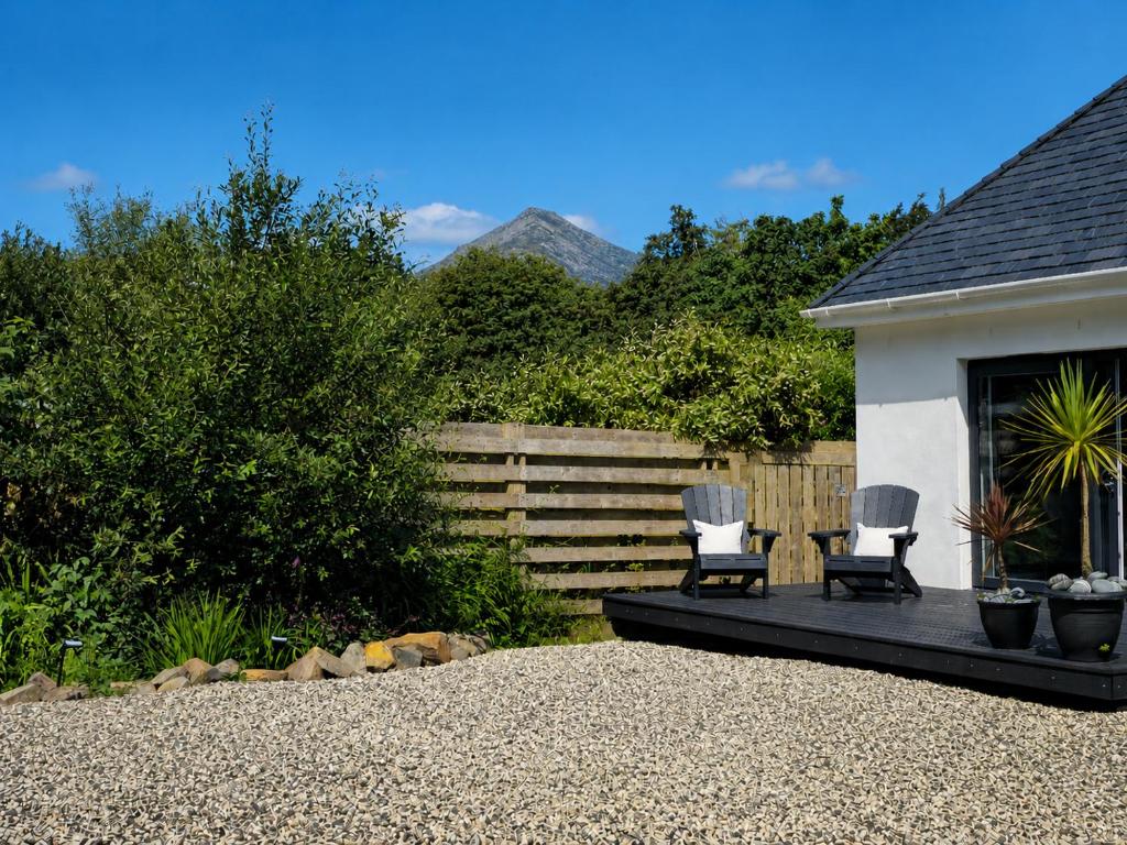 two chairs sitting on a patio in a backyard at Wee Catriona in Brodick