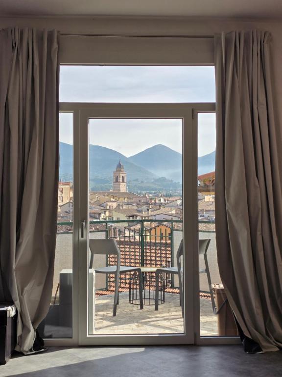 a sliding glass door with a view of a city at Vista Duomo Foligno in Foligno