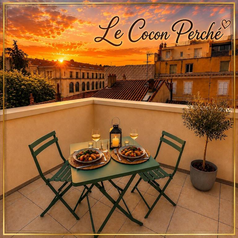 a table with two plates of food on a balcony at Le Cocon Perché - Centre Ville - Parking - Clim in Valence