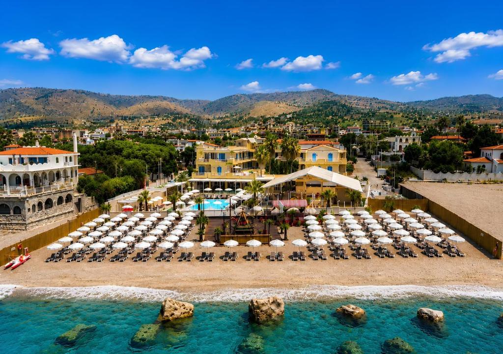an aerial view of a resort with chairs and a pool at Didimos Resort in Reggio di Calabria
