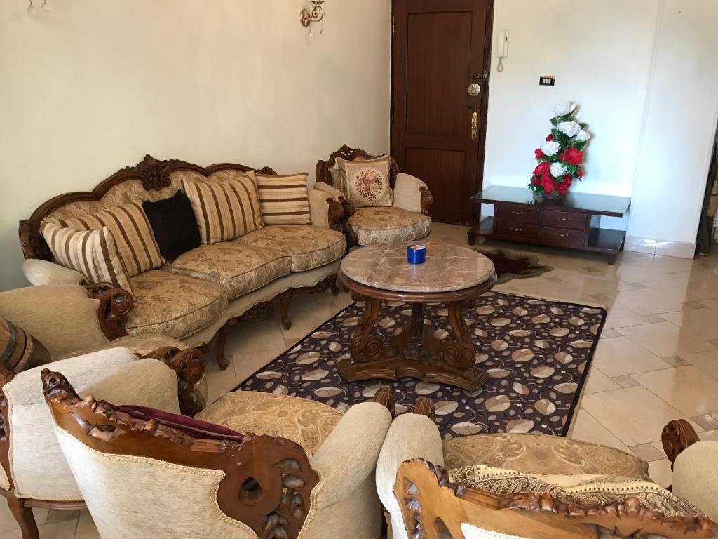 a living room with couches and a coffee table at New Maadi Apartment in Cairo