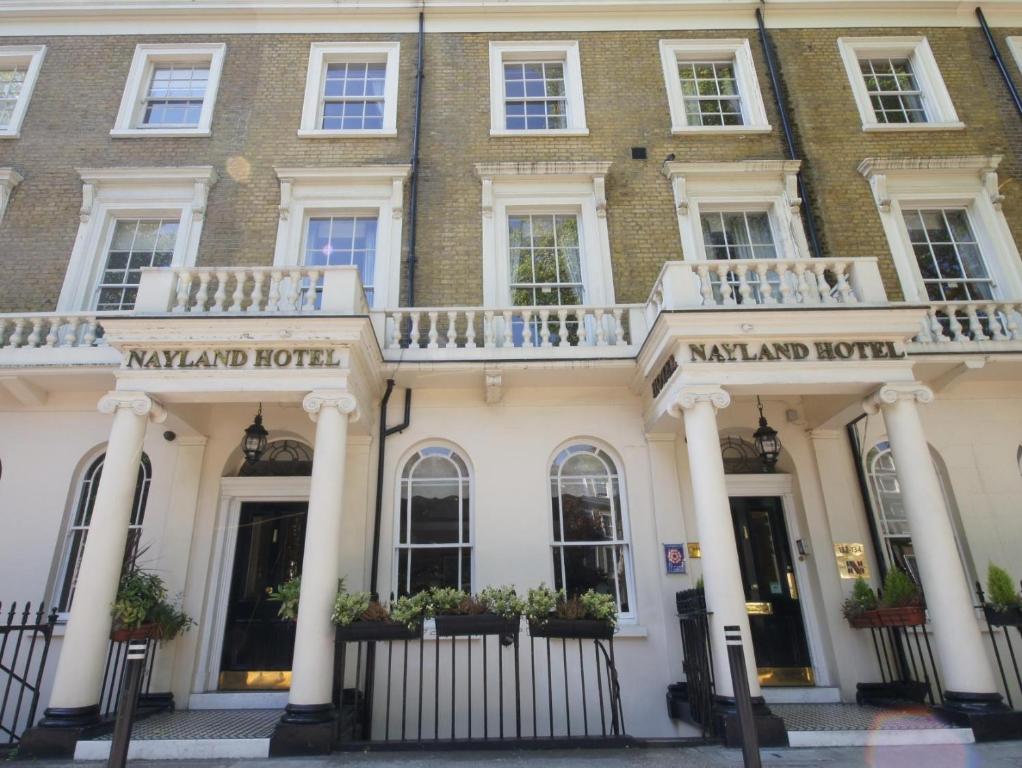 a large white building with white columns at The Nayland Hotel in London