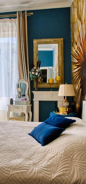 a bedroom with a large bed with a mirror at Chambre d'hôtes Bounty - terrasse, cuisine privée, garage in Olliergues
