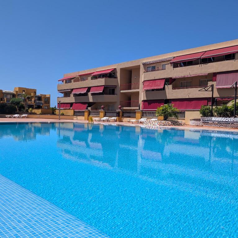 a large swimming pool in front of a building at CHC - Olivia Sunset II in Puerto de Santiago