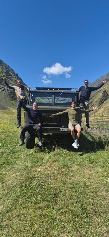 a group of people sitting on the back of a car at Khinalig Shaiq Guest House in Xınalıq