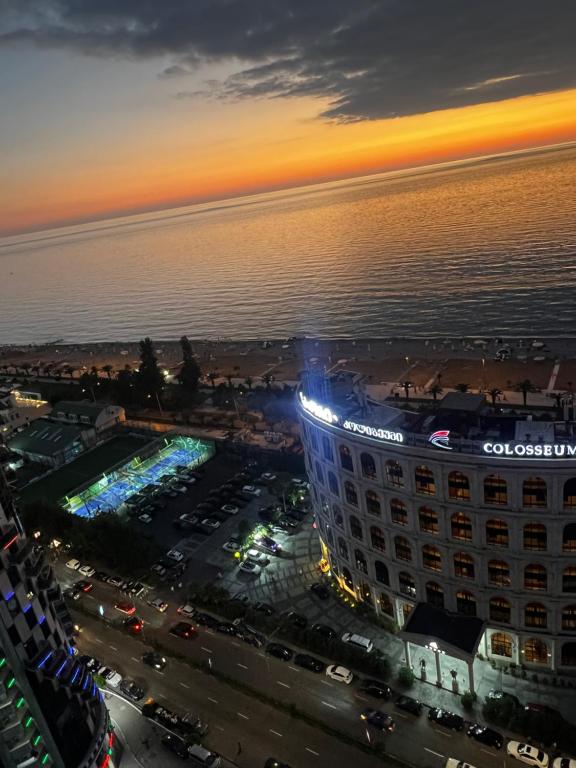 an aerial view of a hotel at night with the ocean at Luxury South Beach Hotel in Batumi