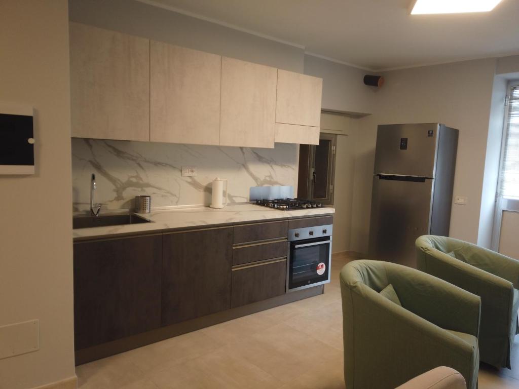 a kitchen with a sink and a refrigerator at La Casa del Principe in Alì
