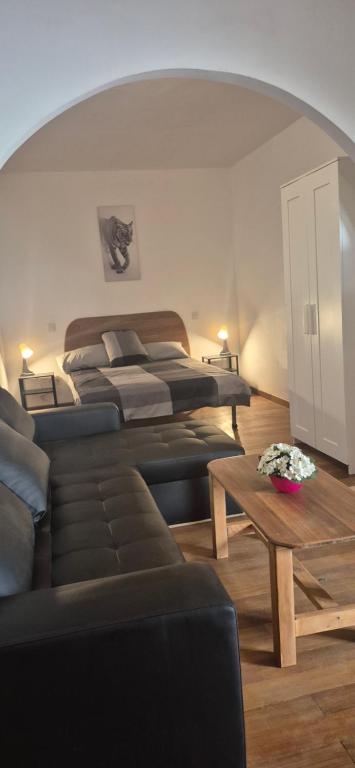 a living room with a bed and a table at The Loft'y #3 in Famara