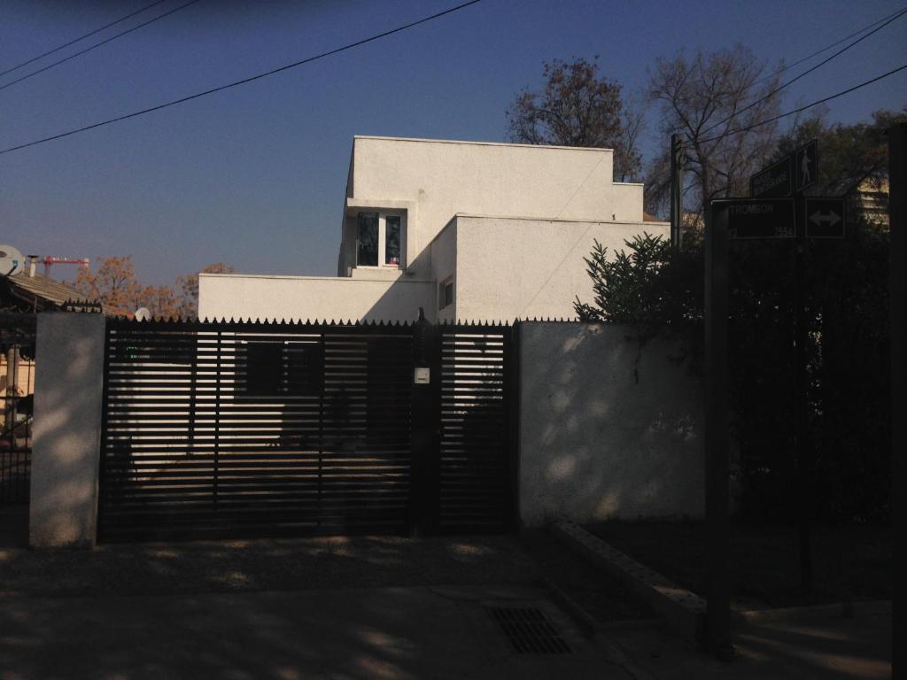 a white house with a fence in front of it at Maowil Home in Santiago