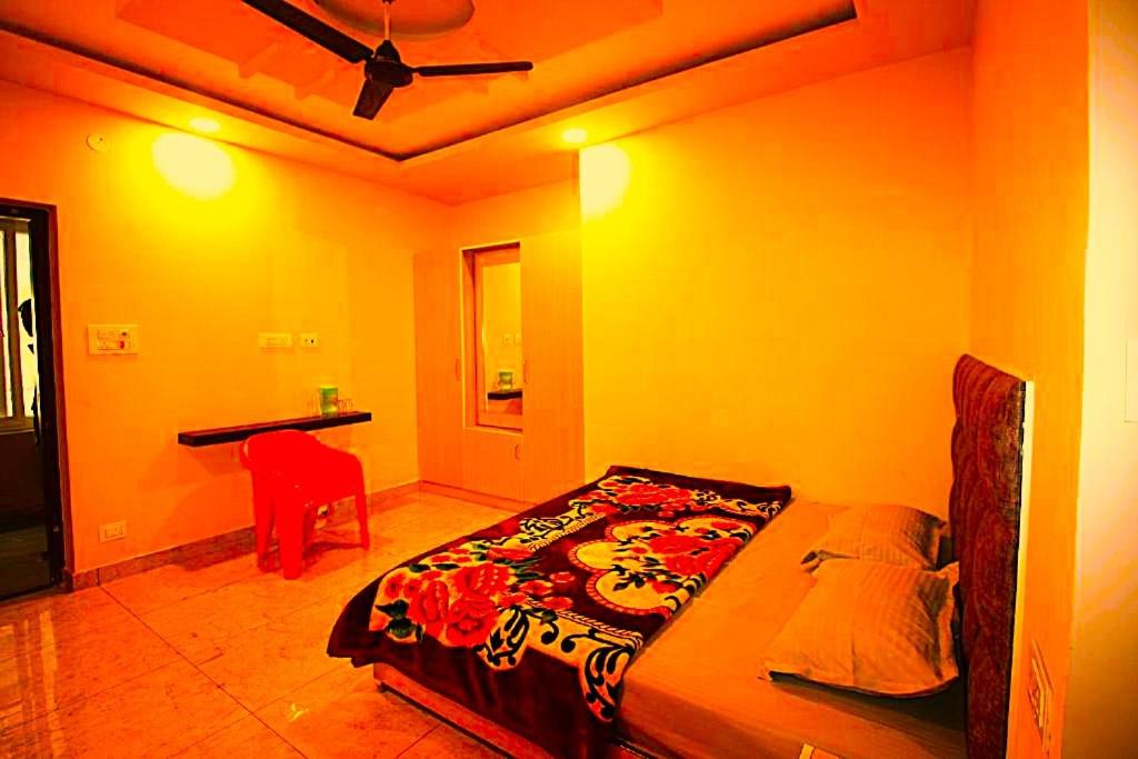 a bedroom with a bed and a desk in it at hotel shivalik palace in Dhanbād