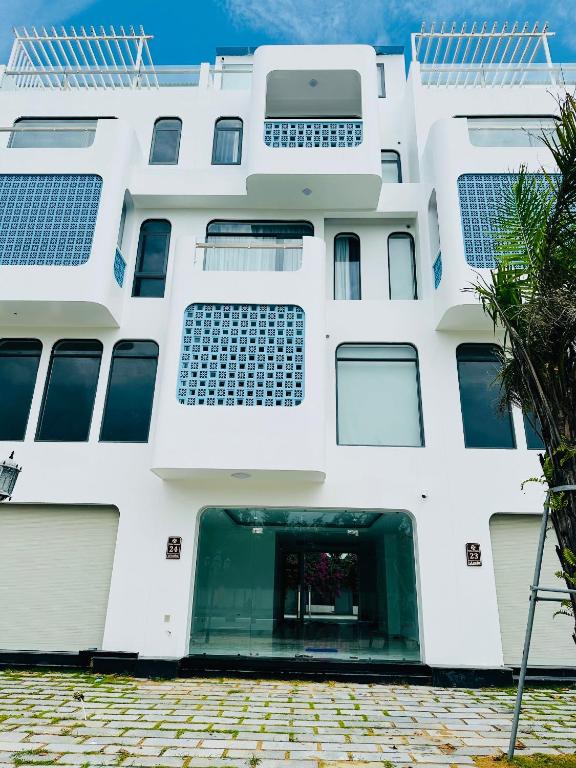 a white building with solar panels on it at Aviera Boutique in Liên Trì (4)