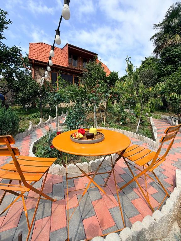 a table and chairs sitting on a patio at Sunshine House in Kutaisi