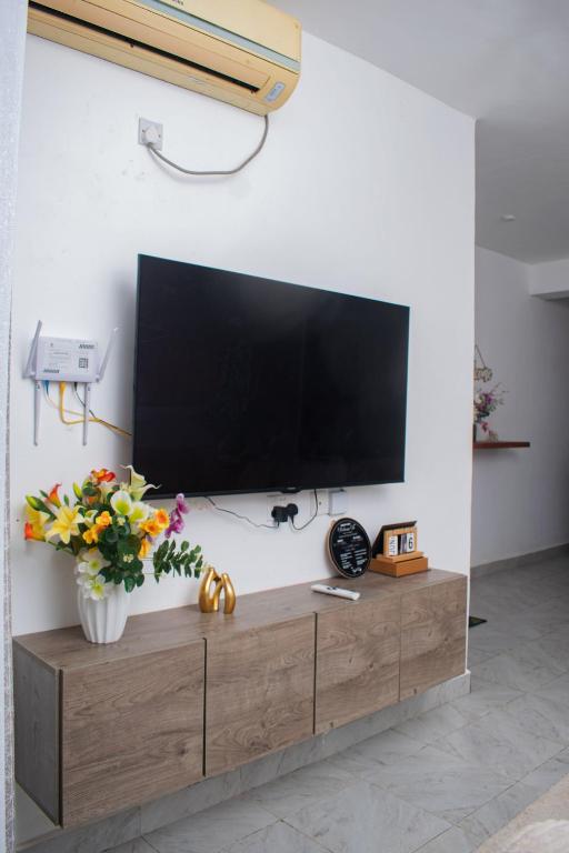 a flat screen tv on a wall in a living room at Vista del mar homes in Malindi