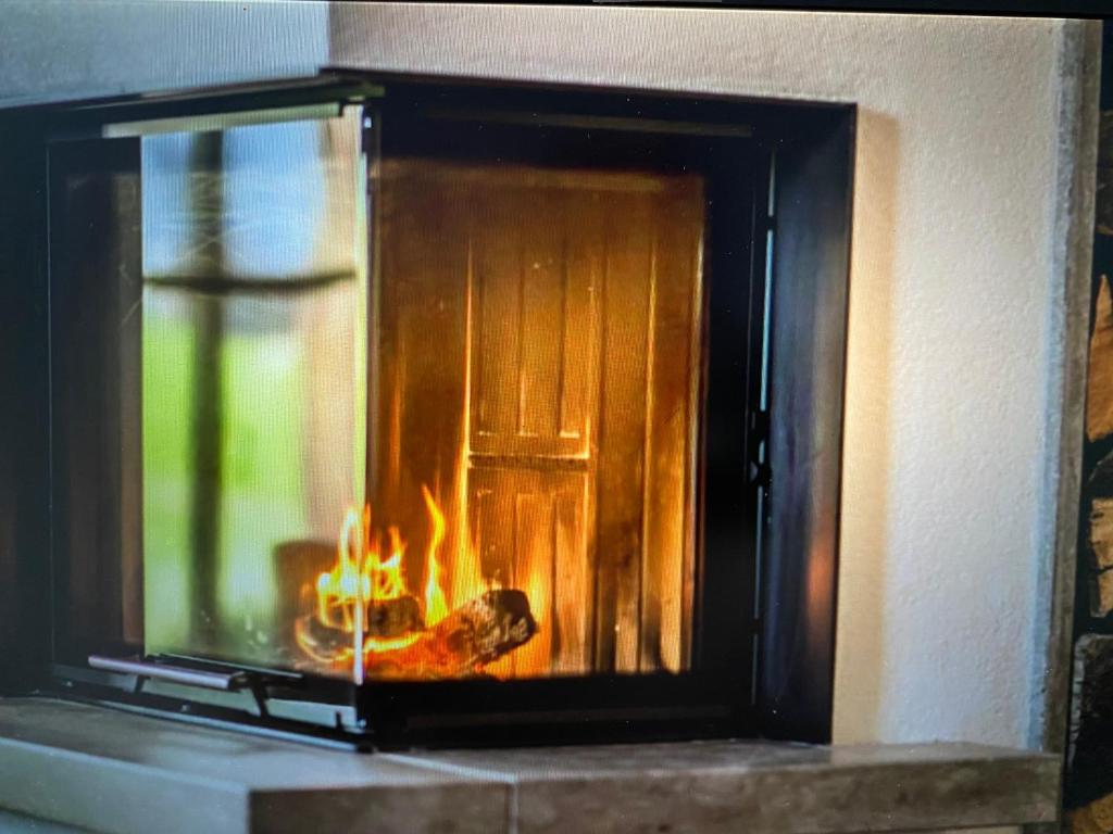 a fire in a brick oven with flames in it at Casa Belluno in Belluno