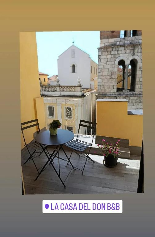 a patio with a table and chairs on a balcony at La Casa del Don in Capua
