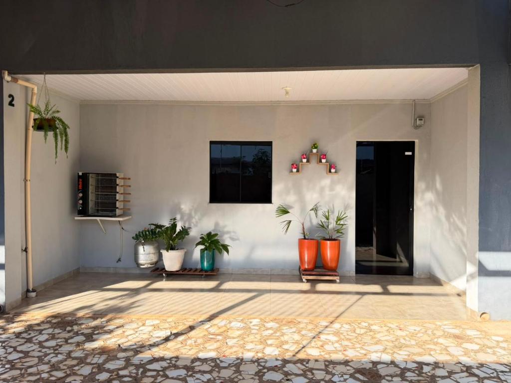 a room with potted plants on a wall at Casa do Graf 2 in Sorriso