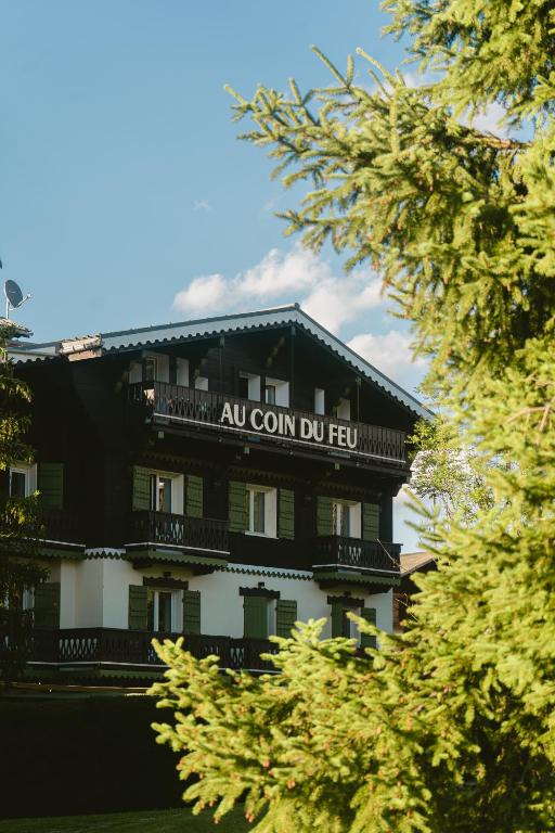 a building with a sign on the side of it at Au Coin Du Feu in Megève