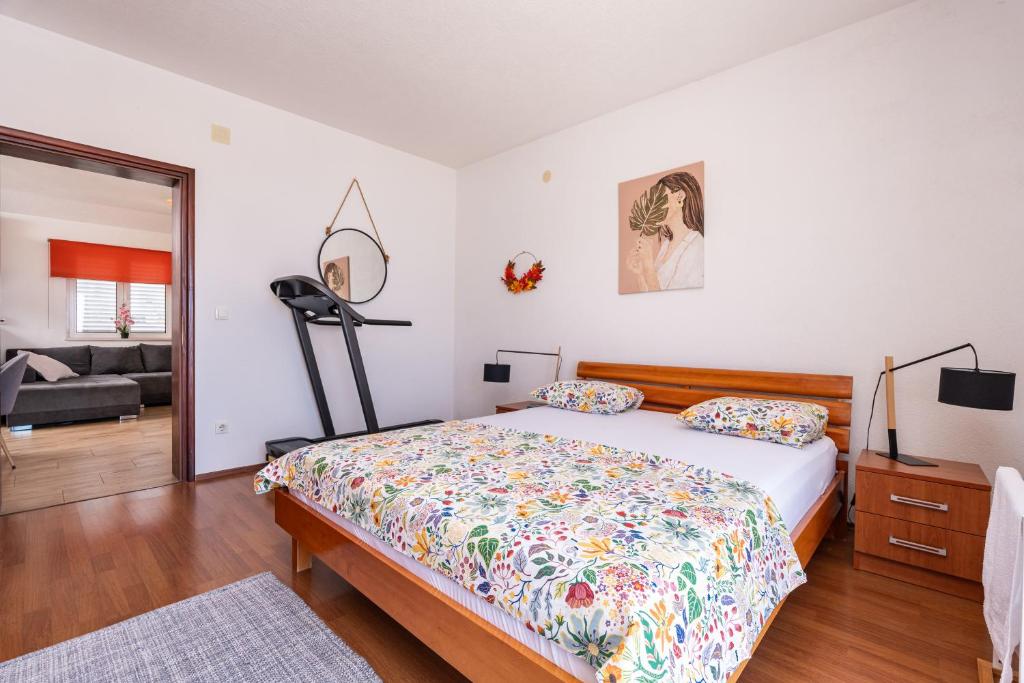 a bedroom with a bed and a living room at Apartments Joy in Cavtat