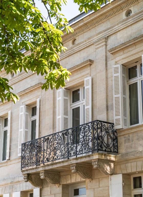 a balcony on the side of a building at La Villa des Vignes in Saint-Émilion