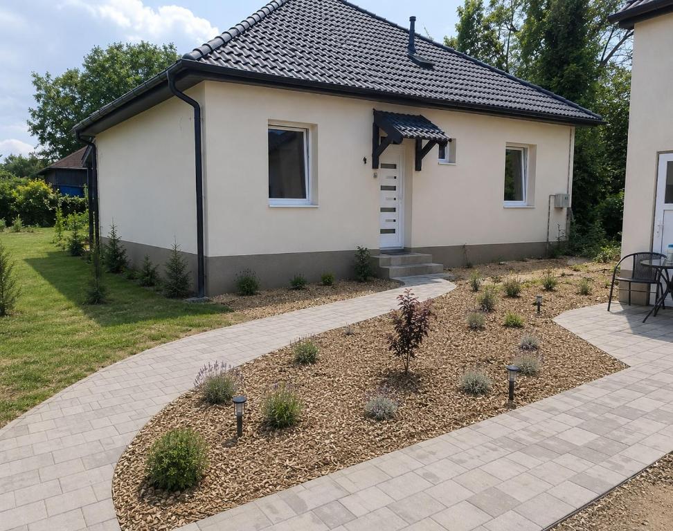 a house with a garden in front of it at Parkside Home in Törökbálint