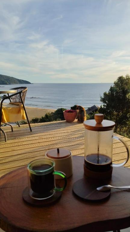 two cups of coffee on a table with a view of the beach at Refugio en Tril tril in Bahía Mansa
