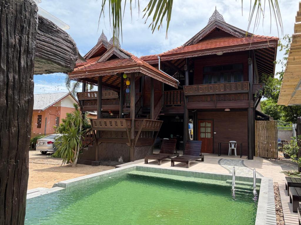 a house with a swimming pool in front of it at Fueangfu Pool Villa Chaweng in Chaweng