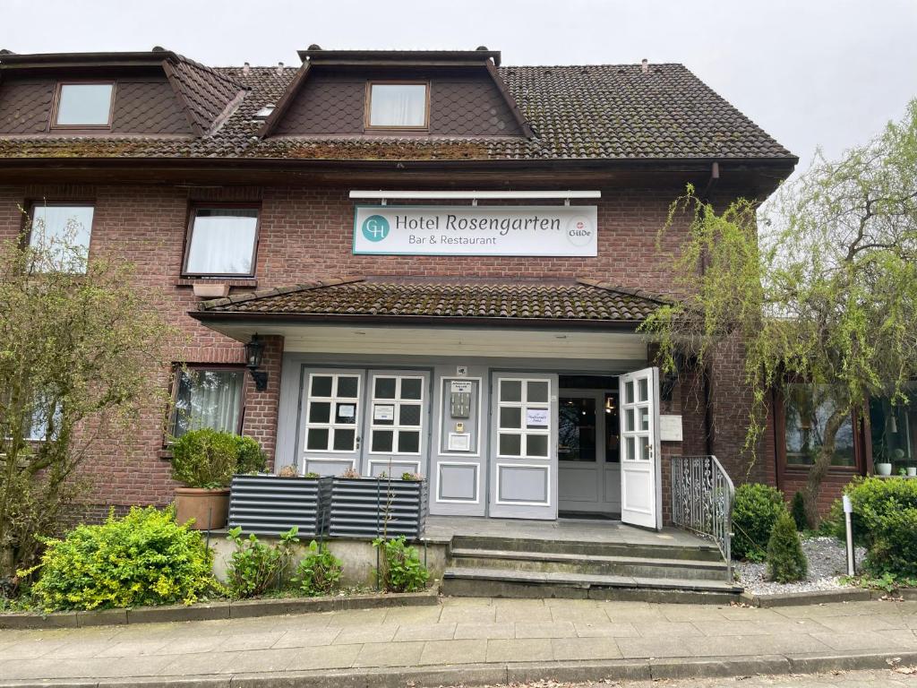 a house with a sign on the front of it at G&H Hotel Rosengarten in Rosengarten