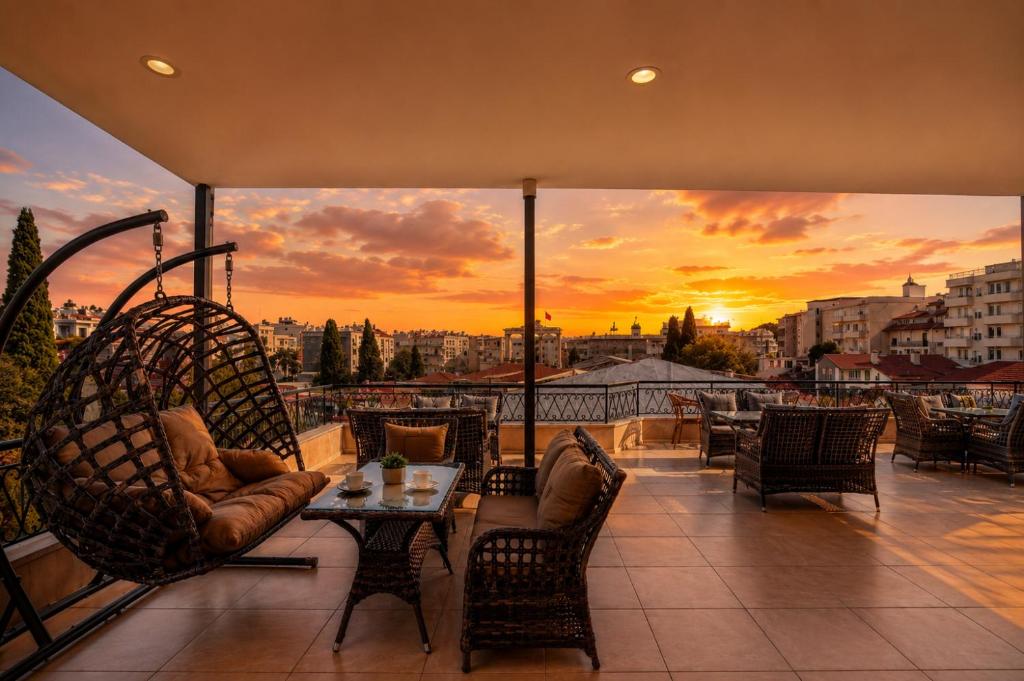 a balcony with a sunset view of a city at Antalya D&D Terrace in Antalya