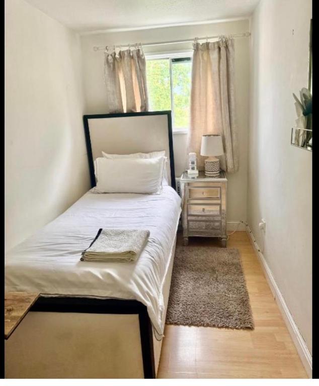 a small bedroom with a bed and a window at Pendleton in Peterborough