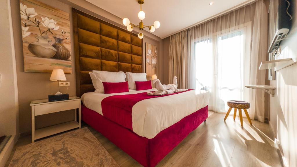 a bedroom with a large bed and a large window at RENT-INN Suites Hotel in Rabat