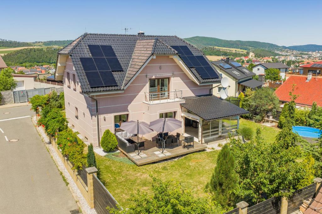 a house with solar panels on the roof at Luxusní vila Serenity 15 min od Prahy in Beroun