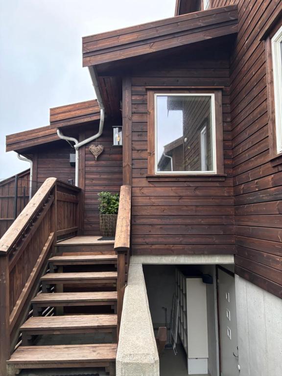 a wooden house with stairs leading up to it at Cozy Scandinavian Retreat in Sola
