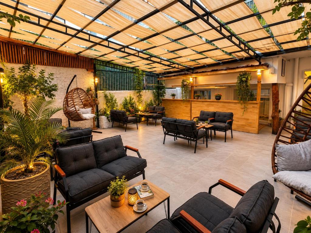 a patio with couches and chairs and a table at Antalya D&D Garden in Antalya