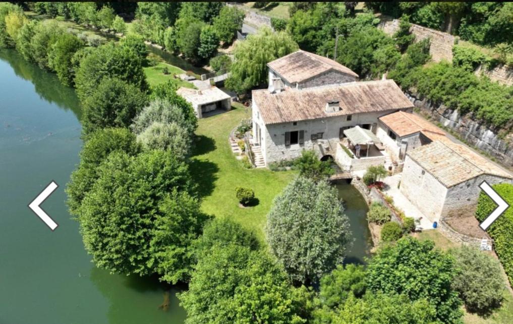 an aerial view of a house on a river at le moulin d'âne à niort in Niort