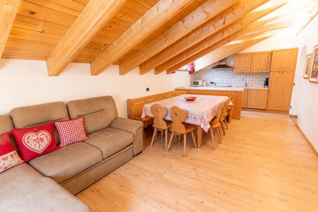 a living room with a couch and a table at Rossetti Big by AMA Val di Fassa in Pozza di Fassa