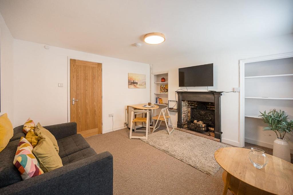 a living room with a couch and a fireplace at 10 Northgate, Beccles in Beccles