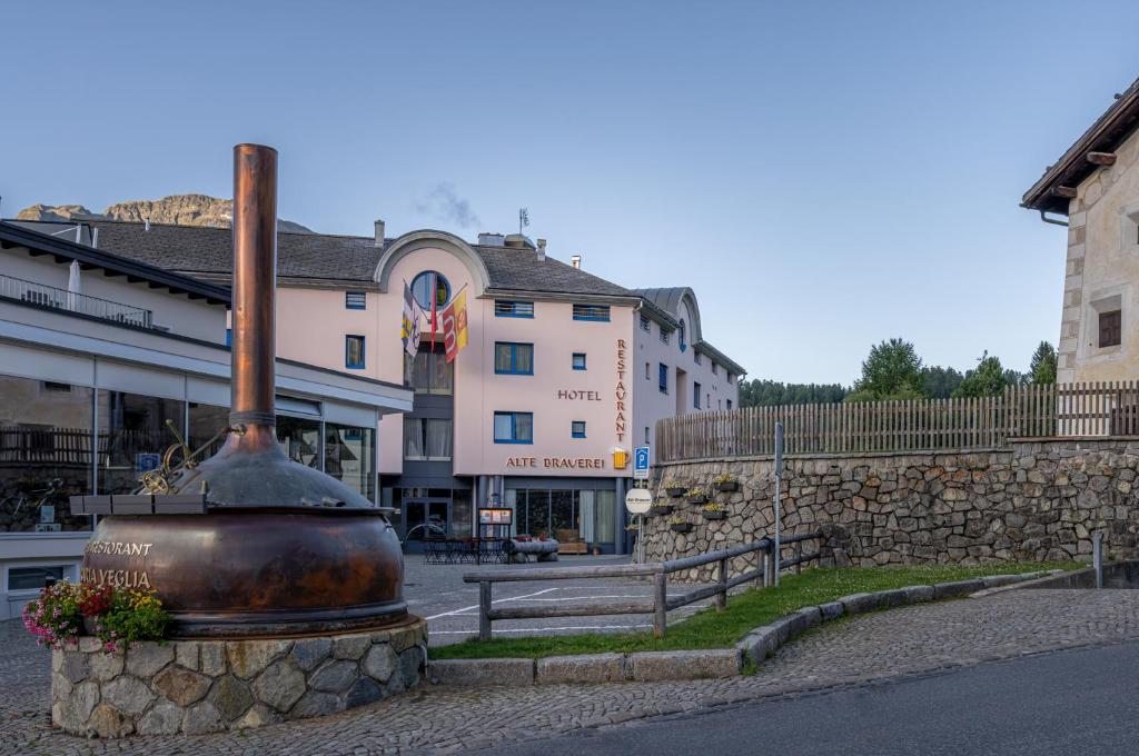 a large pot sitting in the middle of a street at Hotel Restaurant Alte Brauerei in Celerina