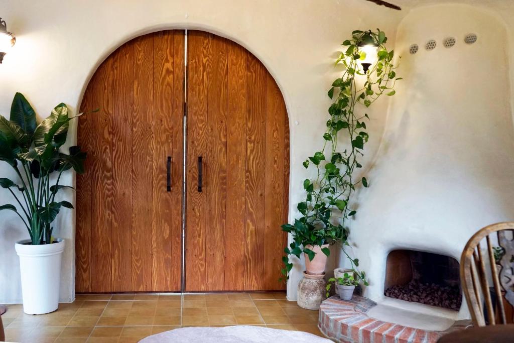 a large wooden door in a room with plants at 공간서시 in Chin-dong