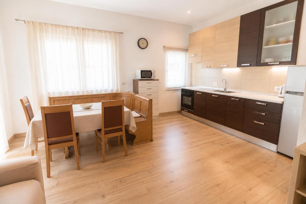 a kitchen with a table and a dining room at Appartamenti Col Rodella by AMA Val di Fassa in Campitello di Fassa