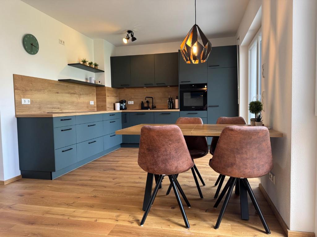 a kitchen with a wooden table and brown chairs at Ferienwohnung "Große Auszeit" in Schongau