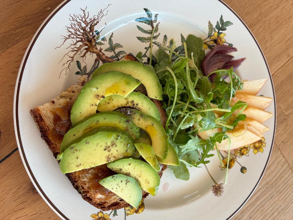 a plate of food with avocado and a salad at BnB Paradiso in Carloforte