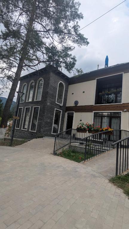 a building with a fence in front of it at hotel G&G in Tsaghveri