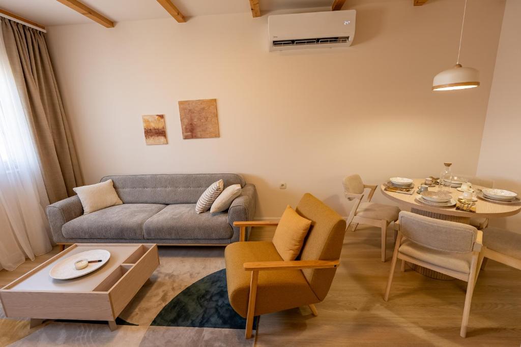 a living room with a couch and a table at Avila Casa in Podgorica