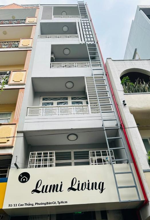 a building with a sign that reads unit living at Lumi living hostel in Ho Chi Minh City