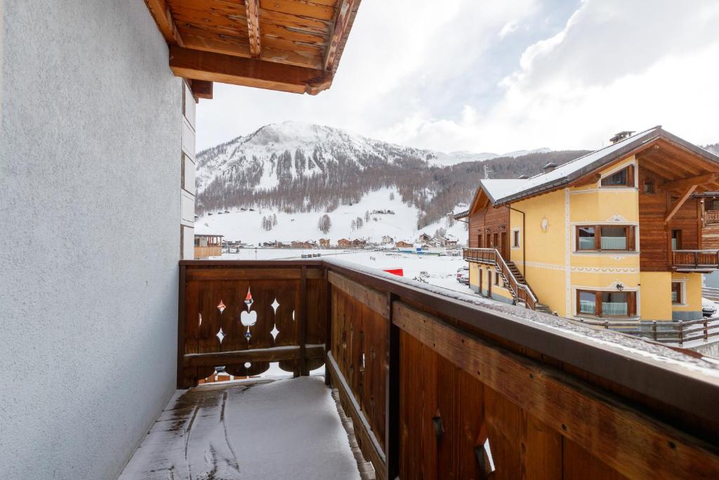a balcony with a view of a snow covered mountain at Albergo Caravasc in Livigno