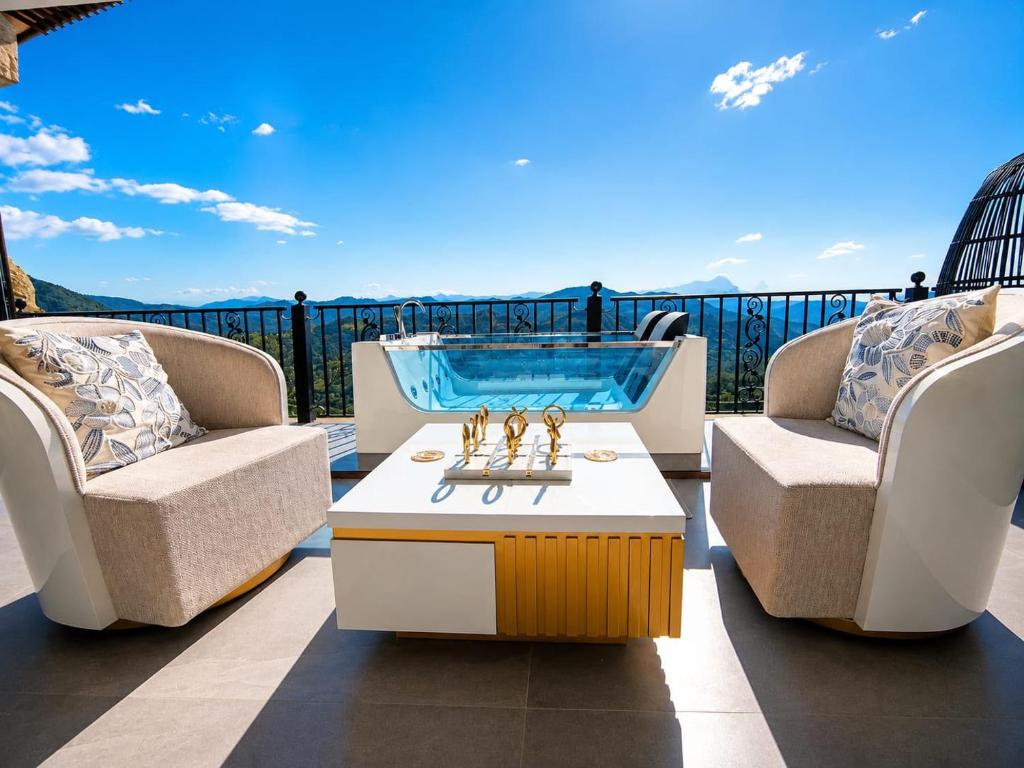 a patio with two chairs and a hot tub at La Colina Resort SAS in La Vega