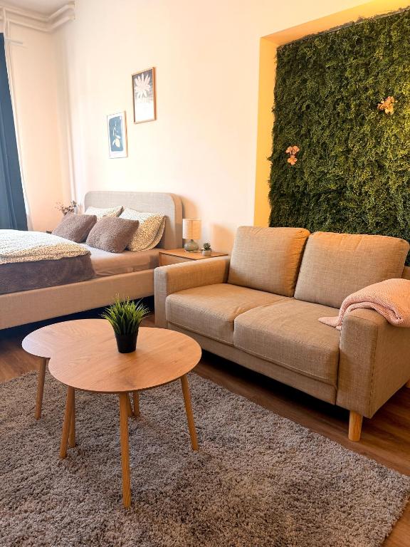 a living room with a couch and a bed at Apartments Chloe - Top 3 in Hollabrunn