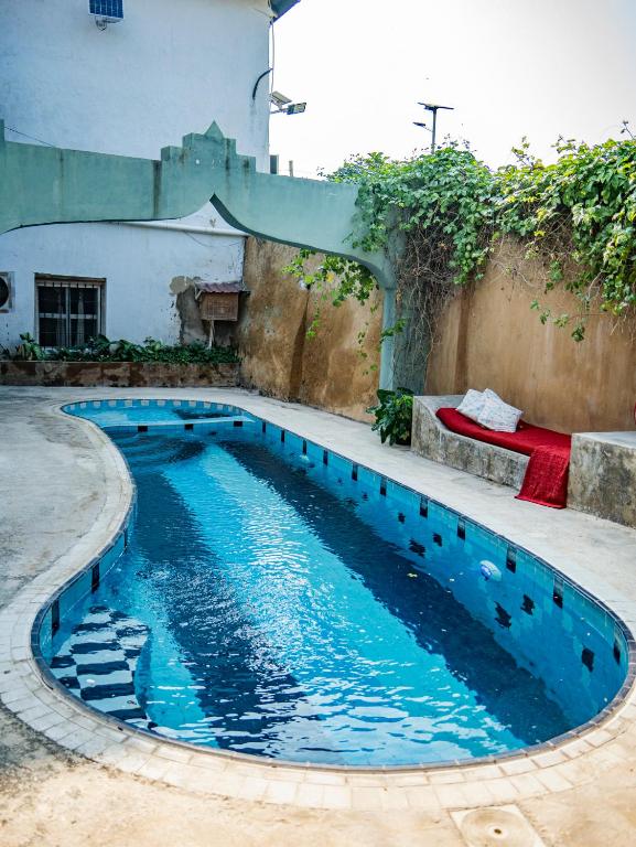 a swimming pool in the middle of a yard at Old Stone Boutique Lodge in Bagamoyo