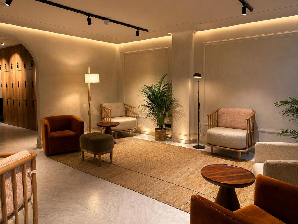 a lobby with chairs and a couch and a table at Caledonian in Barcelona