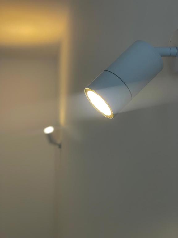 a light hanging from a ceiling in a room at Bliss home in Watamu